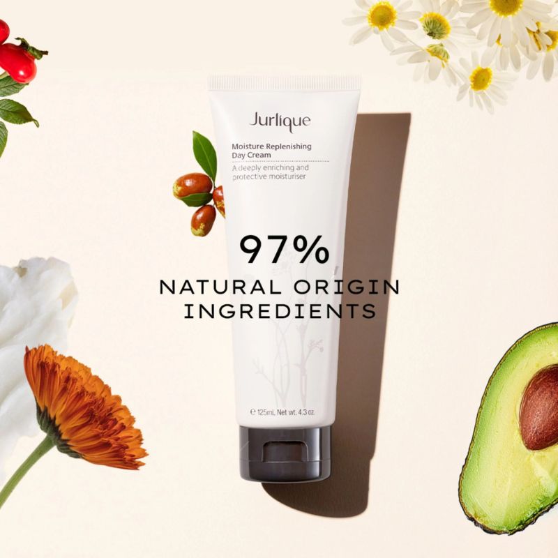 Jurlique moisturizing cream with natural ingredients and flowers on a light background