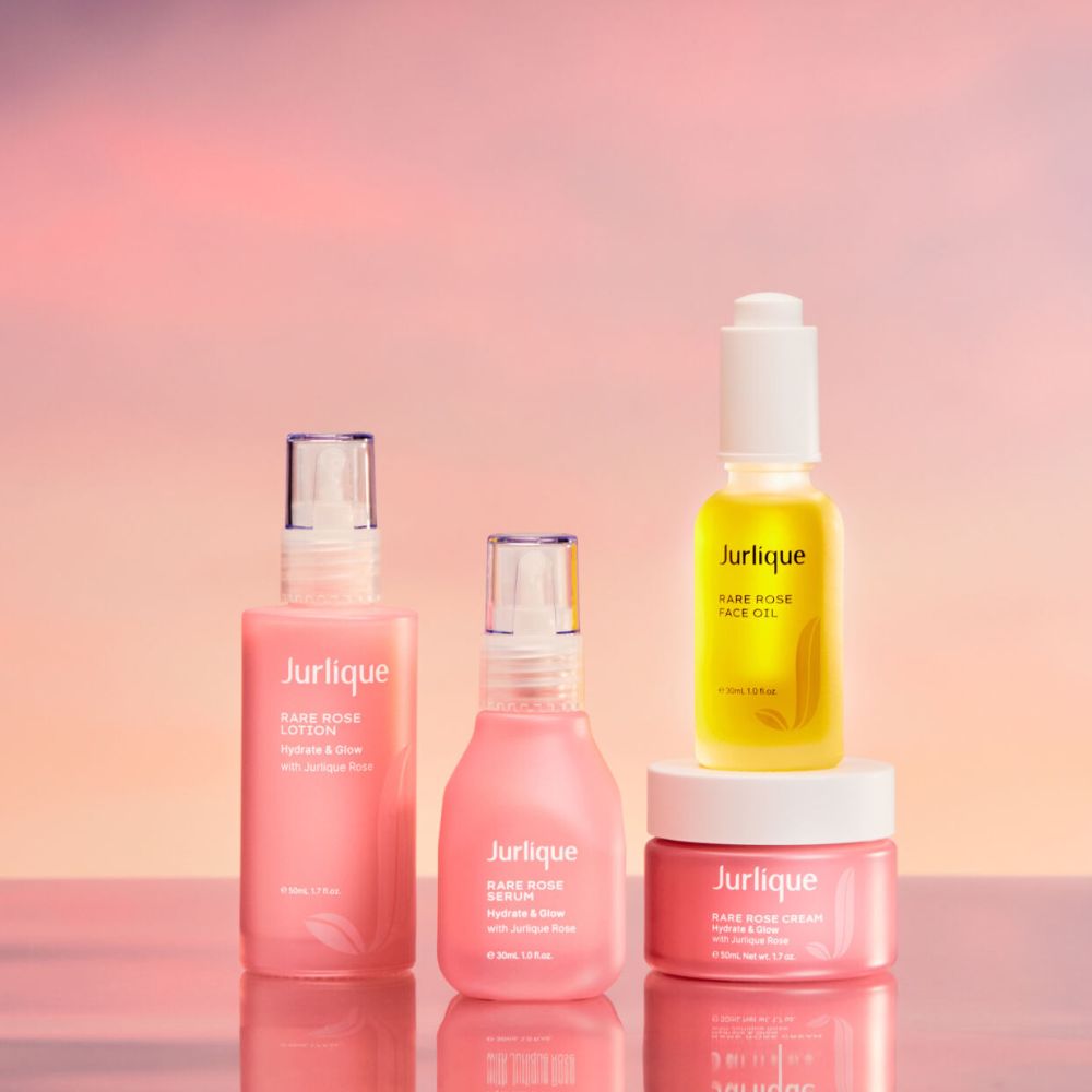 Jurlique skincare products on a gradient pink background