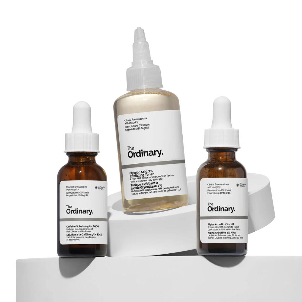 Three 'The Ordinary' skincare bottles on a white background